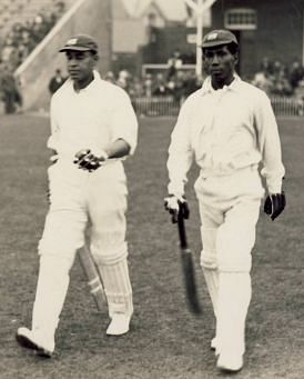 Clifford Roach (Right) walks out to open the innings in West Indies' maiden Test